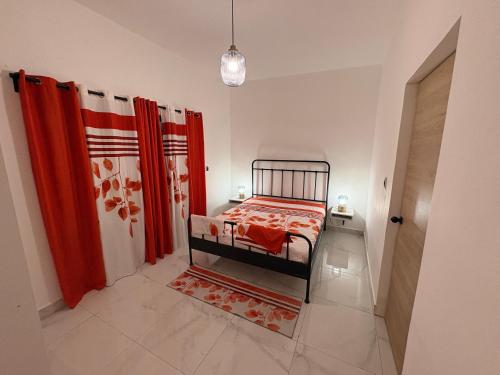 a bedroom with a bed and a red curtain at Apartamento completo punta cana in Punta Cana