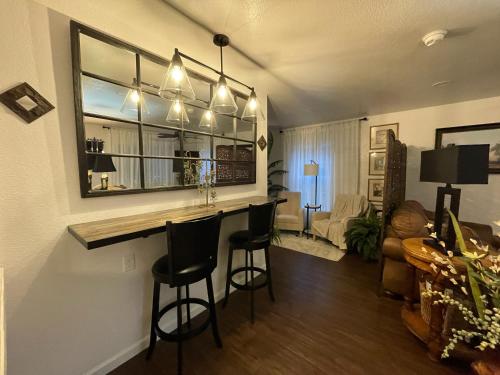 a kitchen with a bar with chairs and a living room at Two Sisters Inn at the Courtyard in Ahwahnee