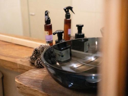 a sink with three bottles on a counter at Must Go Centro de Bienestar in Medellín