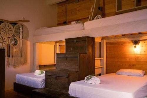 two bunk beds in a room with white sheets at Must Go Centro de Bienestar in Medellín