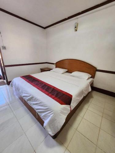 a bedroom with a large bed in a room at PC Palace Hotel in Sakon Nakhon