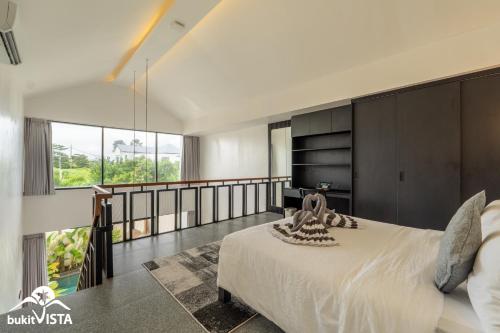 a bedroom with a large bed and a balcony at Villa Lyma by Bukit Vista in Pererenan