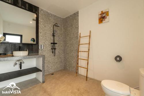 a bathroom with a toilet and a sink at Villa Lyma by Bukit Vista in Pererenan