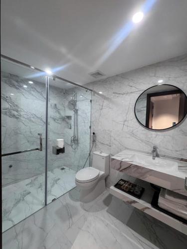 a bathroom with a toilet and a sink and a shower at Thuỳ Dung 68 Hotel in Dong Hoi
