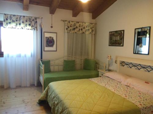 a bedroom with two green beds and a window at Country House Salomè in Musile di Piave