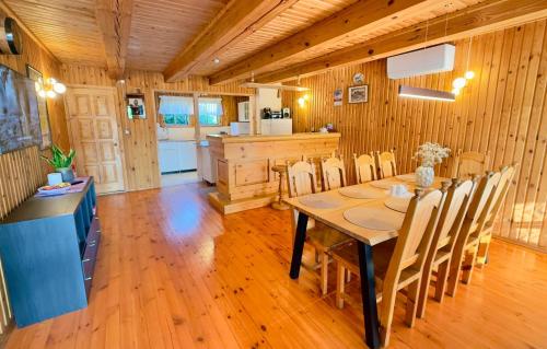a kitchen and dining room with a table and chairs at Anette's Holiday House in Otepää