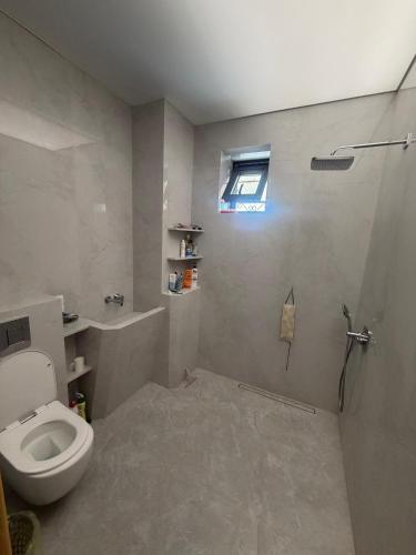a bathroom with a toilet and a window at Visit Balykchy in Balykchy