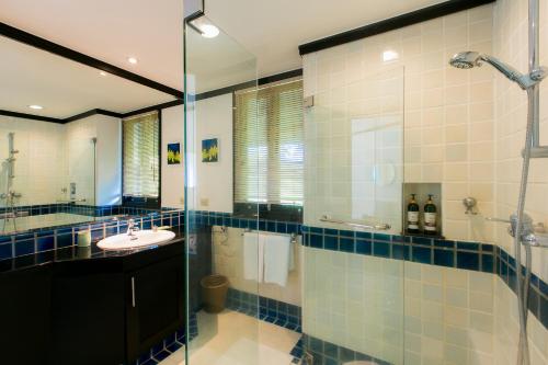 a bathroom with a glass shower and a sink at Katamanda Villa Jade A6 Seaview Kata Beach in Kata Beach