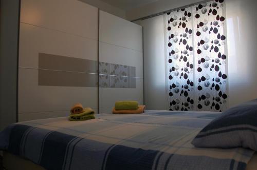 a bedroom with a bed with a blue blanket at Apartment Spanjol in Banjol