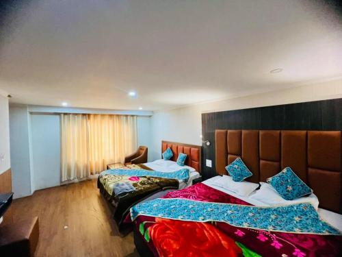 a hotel room with two beds and a window at MGallery in Srinagar