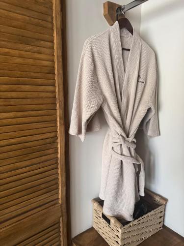 a robe hanging on a rack in a room at Maple Resort in Santa Rosa