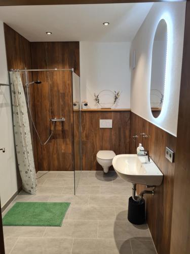 a bathroom with a shower and a sink and a toilet at Zimmer auf'm Hof in Gerabronn