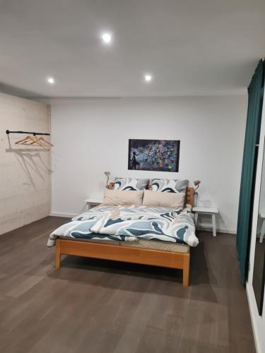 a bedroom with a bed in a white room at Zimmer auf'm Hof in Gerabronn
