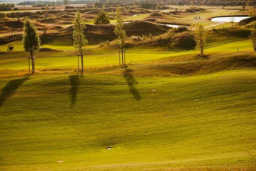 a view of a golf course with trees and grass at Hotel TheGreen in Cologne