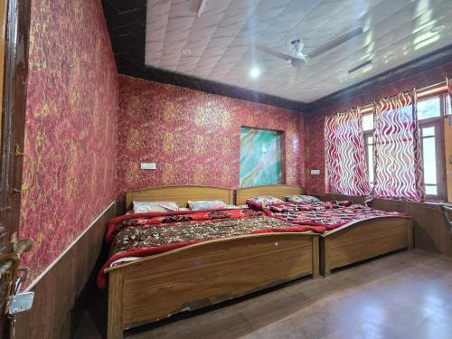 a bedroom with a wooden bed in a room at Alamdar guest house in Srinagar