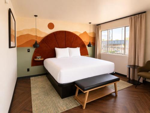 a bedroom with a large white bed and a window at The Wesley Boutique Hotel Page, AZ in Page
