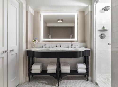 a bathroom with a sink and a mirror at The Carolina Inn, a Destination by Hyatt Hotel in Chapel Hill