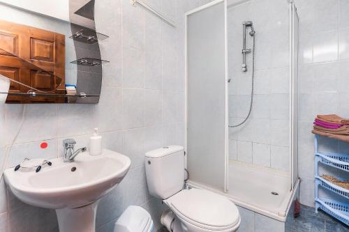 a bathroom with a toilet and a sink and a shower at Vatra Hotel in Yaremche