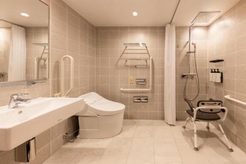 a bathroom with a sink and a shower and a toilet at Caption by Hyatt Namba Osaka in Osaka