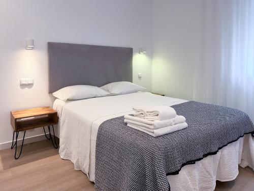 a bedroom with a bed with towels on it at Dani's House - Nazaré in Nazaré