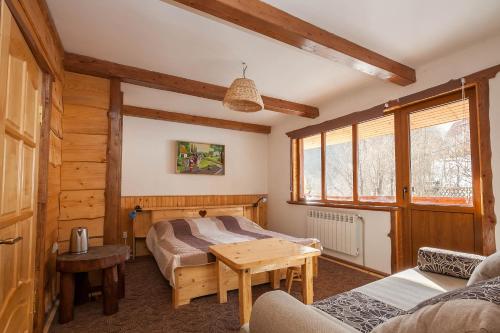 a bedroom with a bed and a table in a room at Vatra Hotel in Yaremche
