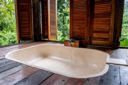 a large bath tub sitting on a wooden deck at Kalpa House Sidemen in Sidemen