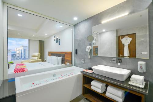a bathroom with a sink and a large mirror at Ginger Jammu , Bari Bramhana in Jammu