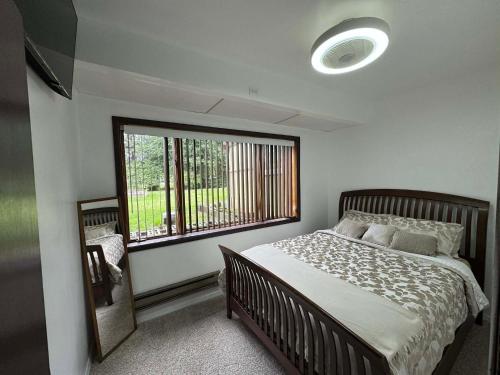 a bedroom with a bed and a large window at Anchorage Fireoved Home Theater Experience in Anchorage