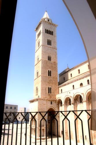 a tall building with a clock tower at Palazzo Filisio - Regia Restaurant in Trani
