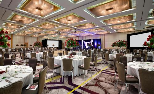 a banquet hall with tables and chairs and a screen at Hyatt Regency Princeton in Princeton