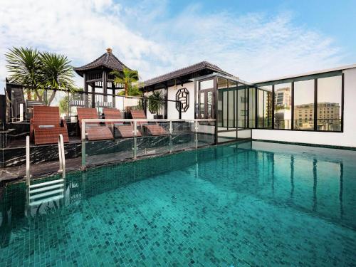 a swimming pool on the roof of a building at THE LEGEND HANOI Hotel in Hanoi