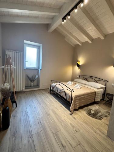 a bedroom with a bed and a window at Casa LEONARDO in CastellʼArquato