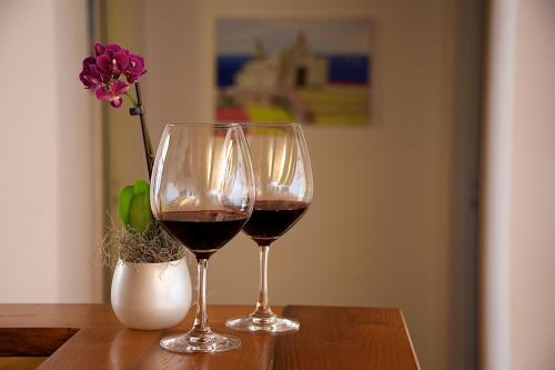 two glasses of red wine sitting on a table at Villa Lieta in Ischia
