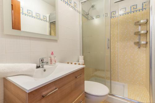 a bathroom with a toilet and a sink and a shower at Apartment Mountain View Torrox town in Torrox