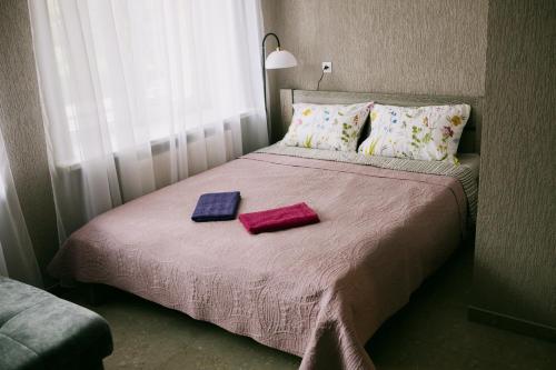 a bedroom with a bed with two towels on it at Marsas 2 in Zarasai
