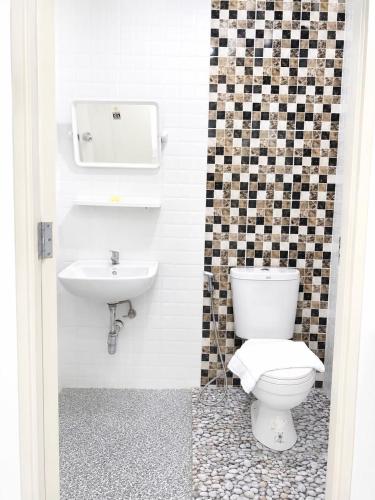 a bathroom with a toilet and a sink at DM udon in Udon Thani