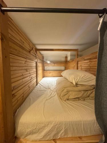 a large bed in a room with wooden walls at Asagaya Iriguchi in Tokyo