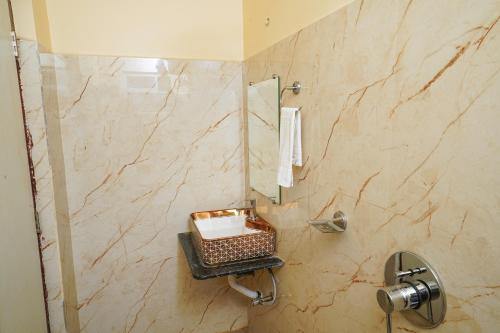 a bathroom with a shower with a toilet and a sink at Hotel Sea Wood in Digha