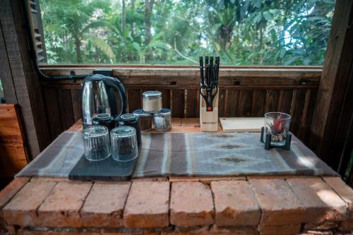 a table with jars on it in front of a window at Folky House Sidemen in Silebeng
