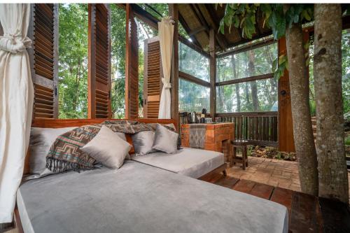 a bedroom with two beds in a tree house at Folky House Sidemen in Silebeng