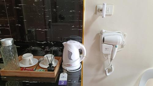 a hair dryer on a shelf in a bathroom at Victoria's Inn in Siquijor