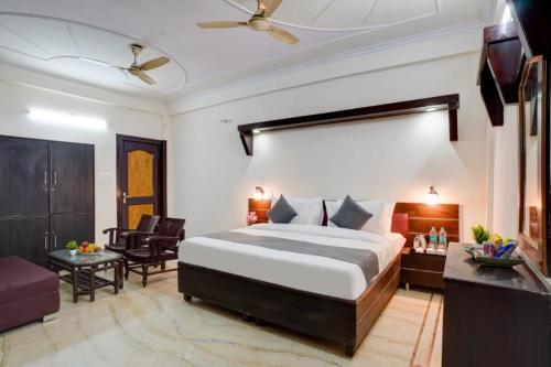 a bedroom with a bed and a living room at Hotel PP Tower - Near Ghaziabad Railway Station in Ghaziabad