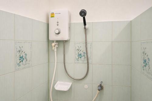 a shower in a bathroom with a blow dryer at 169 Home Resort in Ban Huai Khram