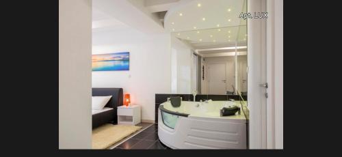 a bathroom with a bath tub and a sink at City Holliday Lux in Belgrade