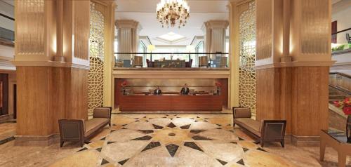 a lobby with two chairs and a large wooden partition at Grand Hyatt Istanbul in Istanbul