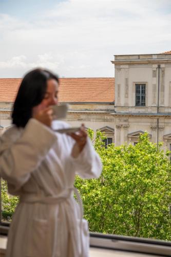 a woman in a white dress holding a cup at Grand Hyatt Istanbul in Istanbul