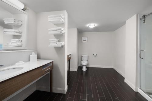 a bathroom with a toilet and a sink and a mirror at Hampton Inn Morristown in Morristown