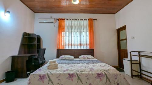 a bedroom with a bed and a window at Margarita Leisure in Wadduwa