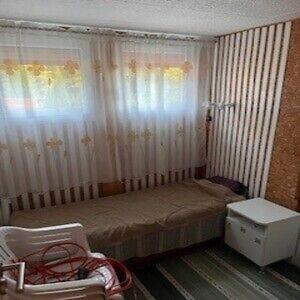 a small bedroom with a bed and a chair at Ostrzycki Raj in Pierszczewo