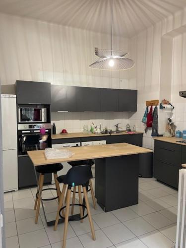 a kitchen with a table and some chairs in it at Magnificent duplex in a former Palace in Chamonix